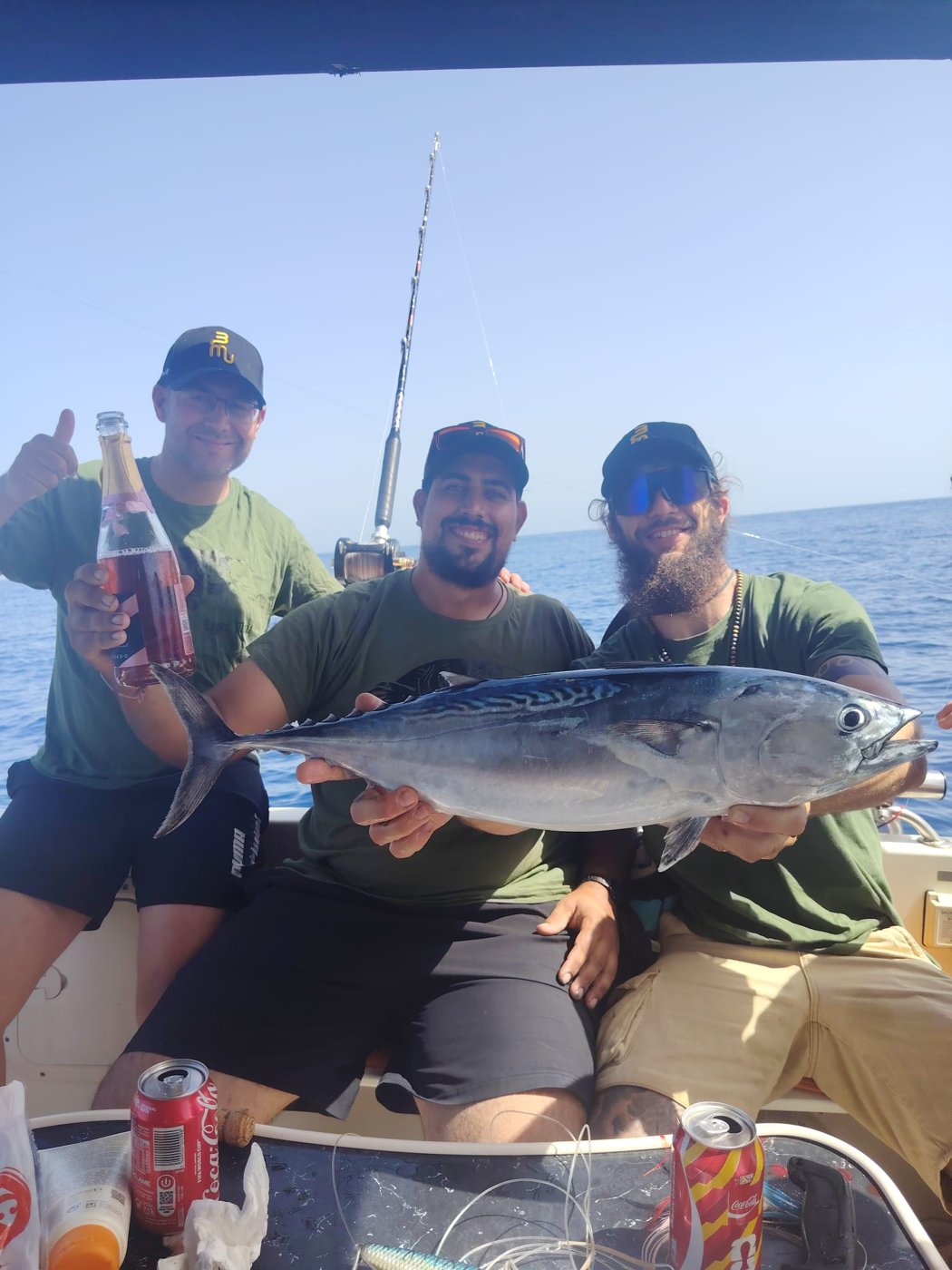 Three anglers with a catch on board the Rodman